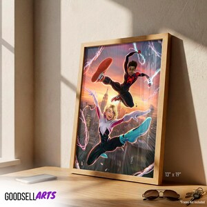 Op de afbeelding: Ingelijste kunstdruk met twee Spider-Man-personages in actie tegen een zonsondergang. Het kunstwerk zit in een houten lijst en meet 33 x 48 cm. Het Goodsell Arts-logo is zichtbaar onderaan.