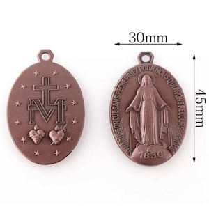 May include: Two bronze-colored oval pendants. One pendant features a cross above the letter "M" with two hearts and stars. The other pendant shows a figure with text and the year 1830. Each pendant is 1.77 inches long and 1.18 inches wide.