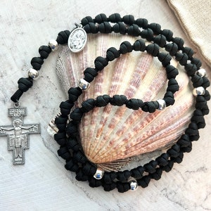Franciscan Crown Knotted Rosary Rope. 2” San Damiano Crucifix. Seven Decades. Metal Alloy Our Father Beads. Black #550 Paracord.