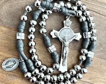 Crocifisso di San Benedetto spesso, rosario cattolico interamente in metallo. Grani da 10 mm. Grani del Padre Nostro con motivo a croce. Medaglia del Santo a scelta. Paracord n. 550.