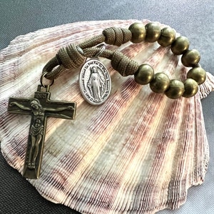 One Decade Bronze Catholic Rosary. Bronze Finish Metal Alloy 10mm Beads. Your choice of Silver Saint Medal. #550 paracord.