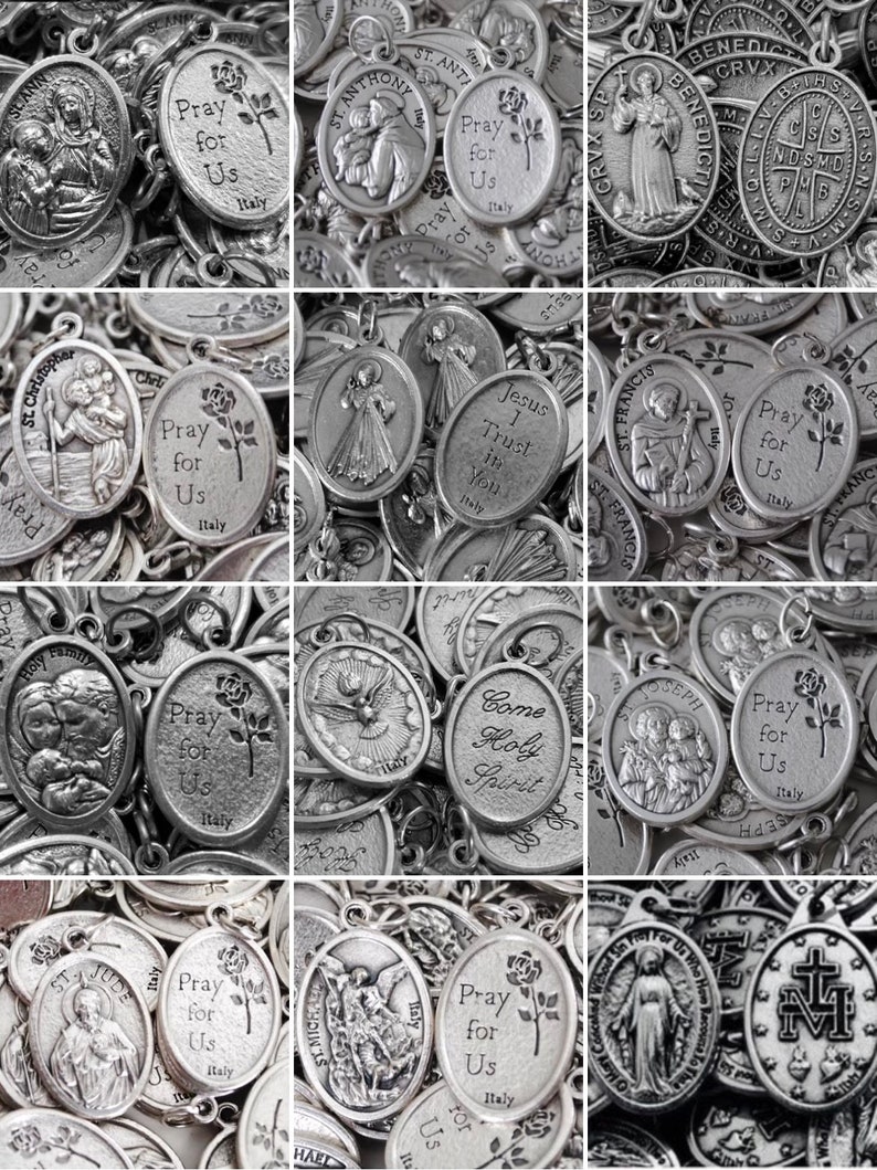 May include: A collection of silver oval-shaped religious medallions with various images and text. The medallions feature images of saints, religious symbols, and text such as "Pray for Us" and "Jesus I Trust in You".