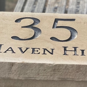 May include: A beige stone house number plaque with the number 35 and the text "HAVEN HILL" engraved in black.