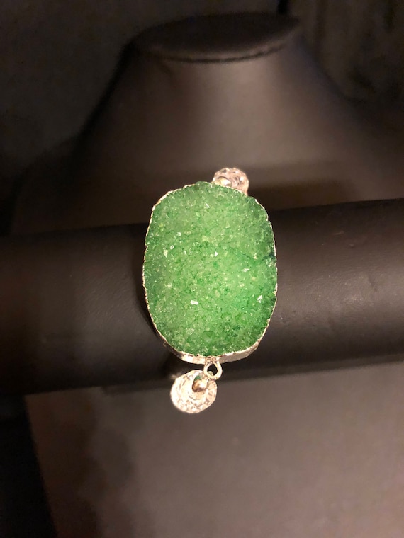 Beautiful large green druzy geode wrapped in silver foil bracelet on a stretchy band with clear beads.