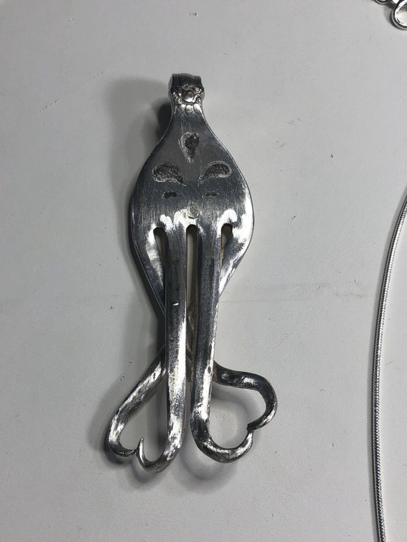 Handmade fork pendant with prongs coming together into hearts