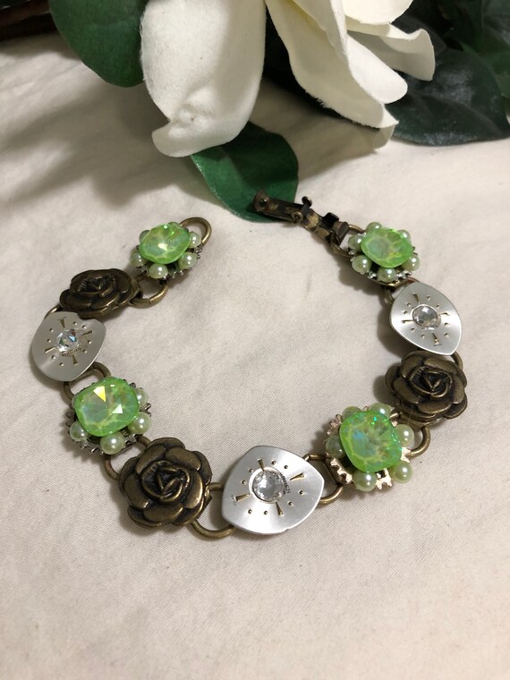 Handmade bracelet of green pearls and stones on a bronze base