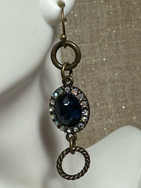 Handmade sapphire blue glass oval crystal surrounded by mystic crystals with bronze circles dangle earrings