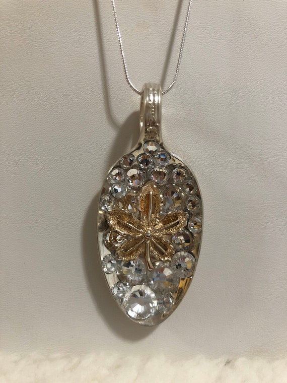 Handmade antique spoon necklace with gold tone oak leaf charm center surrounded by clear Swarovski crystals.