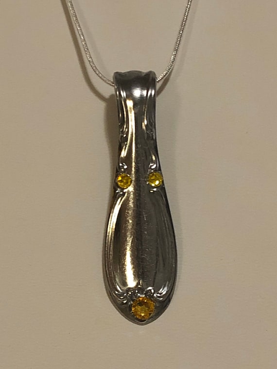 Handmade pendant from spoon handle with yellow Swarovski crystals