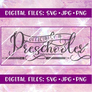 May include: A black and white digital design file for a printable or cut file that says "Officially a Preschooler" with a banner and two pencils underneath. The design is on a pink and white background.