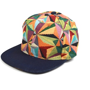 May include: A baseball cap with a colourful geometric pattern and a navy blue brim.