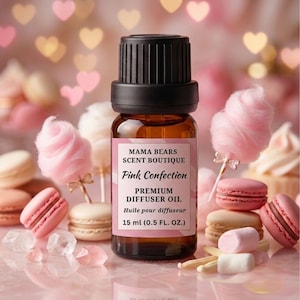 May include: A brown glass bottle with a black cap, labeled "Pink Confection Premium Diffuser Oil, 15 ml (0.5 Fl. Oz.)". The image features pink macarons, cotton candy, and marshmallows. The background has heart-shaped bokeh lights.