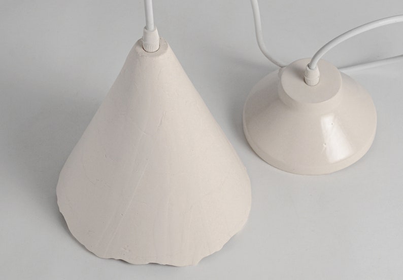 Handcrafted ceramic hanging light fixture for kitchen island with warm diffused lighting effect. White ceramic pendant light fixtures with a simple design. Thefixture is cone-shaped.