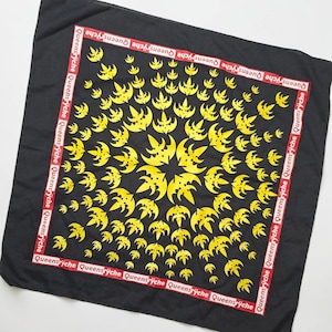 May include: Black square bandana with a repeating yellow bat-like design. The border features the text "Queensryche" in white on a red stripe. The bandana is made of a soft, likely cotton, material.