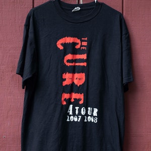 May include: Black t-shirt with a red graphic of "The Cure" and the text "4 Tour 2007 2008".