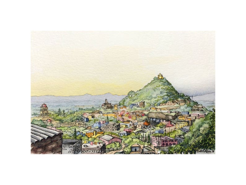 Pu&ograve; includere: Un dipinto ad acquerello che rappresenta una citt&agrave; con una collina sullo sfondo. La collina &egrave; ricoperta di alberi verdi e ha un piccolo edificio in cima. La citt&agrave; &egrave; composta da molti piccoli edifici, alcuni dei quali sono dipinti con colori vivaci. Il cielo &egrave; azzurro chiaro e ci sono nuvole in lontananza.