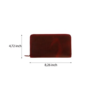 May include: A burgundy leather zippered wallet with measurements of 8.26 inches by 4.72 inches.
