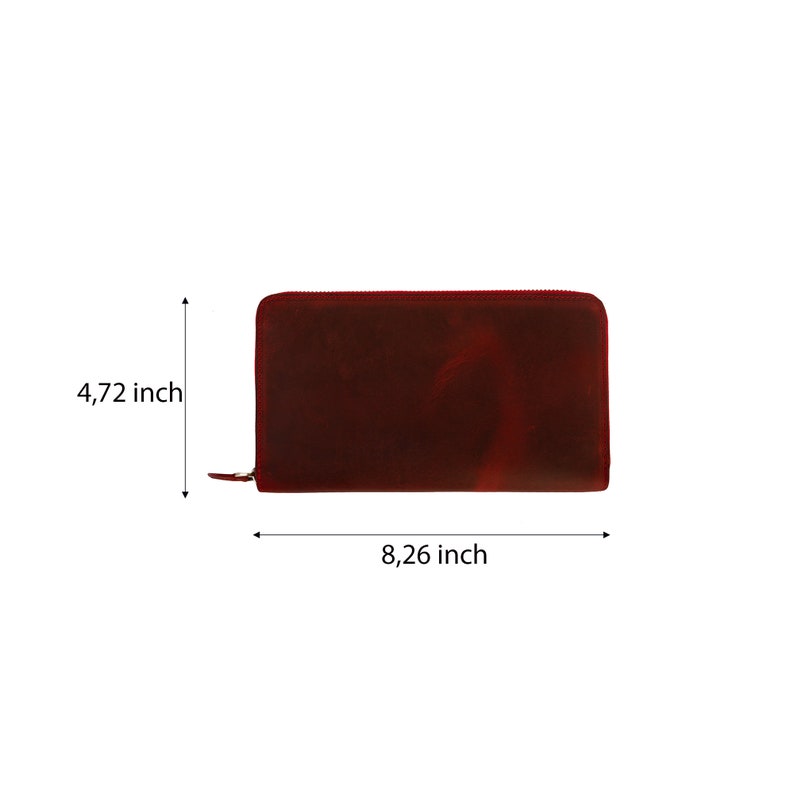 May include: A burgundy leather zippered wallet with measurements of 8.26 inches by 4.72 inches.
