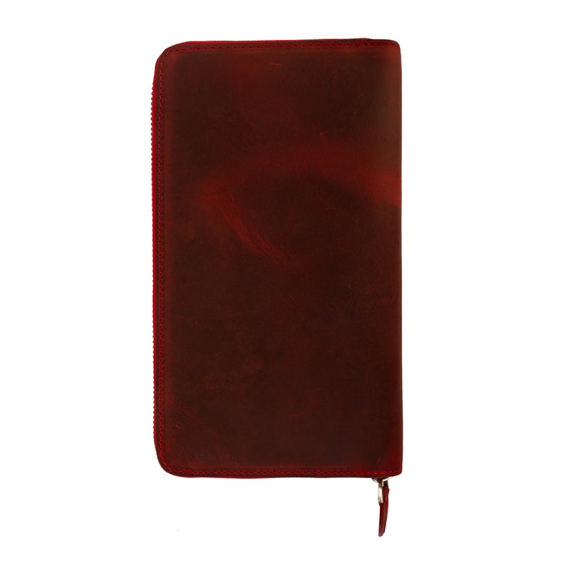 May include: A deep red leather wallet with a zipper closure.