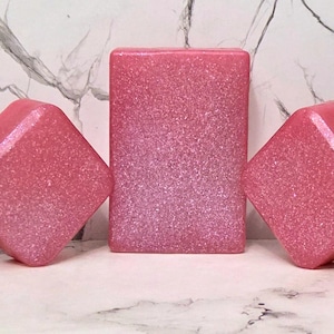 May include: Five pink and white glittery soap bars of various sizes and shapes.