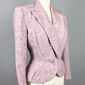 Puede incluir: Una chaqueta rosa con un patr&oacute;n moteado y un cierre de un solo bot&oacute;n. La chaqueta tiene una silueta ajustada y una longitud ligeramente recortada.