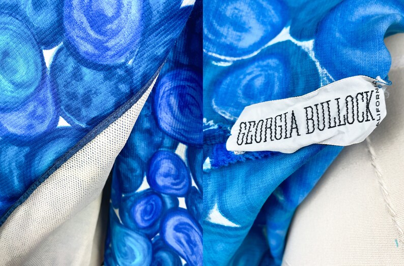 May include: A blue and white patterned fabric with a white tag that reads "GEORGIA BULLOCK" in black text.