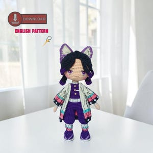 May include: A handmade crochet doll featuring a character with black hair, purple eyes, and a purple and white outfit. The doll has a detailed design with a white coat, purple pants, and matching boots. The image includes the text "DOWNLOAD ENGLISH PATTERN".