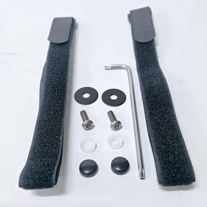 May include: Two black velcro straps, two black plastic washers, two silver screws, two white plastic washers, two black plastic caps, and a silver allen wrench.