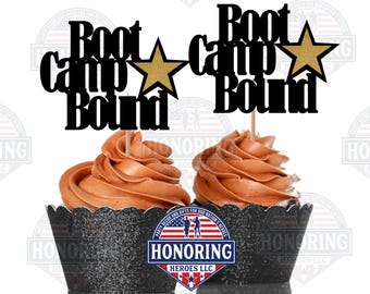 May include: Two cupcakes with chocolate frosting and black glitter cupcake wrappers. Each cupcake has a black cake topper that reads "Boot Camp Bound" with a gold star. The image includes the text "Honoring Heroes LLC".