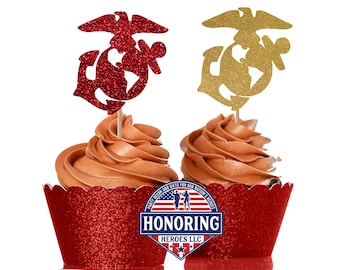 May include: Two cupcakes decorated with red and gold glitter Marine Corps emblems. The cupcakes are in red glitter cupcake liners. The cupcakes are topped with chocolate frosting. The cupcakes are decorated with a red and gold glitter "Honoring Heroes LLC" logo.