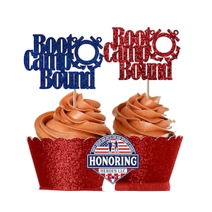 May include: Two cupcake toppers with the text "Boot Camp Bound" in blue and red glitter. The toppers are on top of cupcakes with brown frosting and red glitter cupcake liners. The cupcake liners have a red, white, and blue logo that says "Honoring Heroes LLC".
