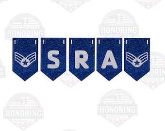 May include: A blue and silver banner with the word "SRA" and two Air Force insignia. The banner is made of glitter paper and is perfect for a military party or celebration.