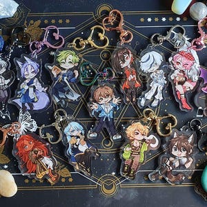 May include: A collection of colourful anime character keychains featuring various characters with different hairstyles and outfits. The keychains are made of clear acrylic and have a glossy finish.