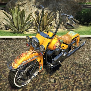 May include: A custom yellow motorcycle with detailed airbrushed artwork on the fenders and fuel tank. The motorcycle features a high handlebar, chrome accents, and a brown seat with a floral design. The front tire has a white sidewall.