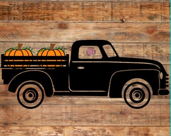 May include: Black silhouette of a vintage pickup truck carrying two orange pumpkins with green vines in the truck bed. The truck is set against a rustic wooden background, evoking a fall harvest theme.