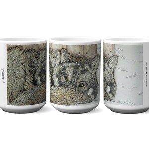 May include: White ceramic mug featuring a detailed illustration of a gray wolf. The artwork wraps around the mug, showcasing the wolf's fur and face. The mug has a large handle and the text "Predalico" and "moonhawkart.com" are visible.