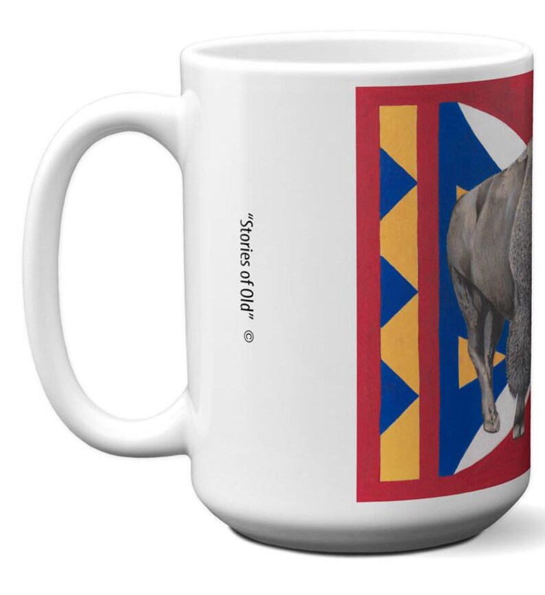 May include: White ceramic mug with a large handle. The mug features a design with a red border, blue and yellow geometric shapes, and a gray animal illustration. The text "Stories of Old" is printed on the side.