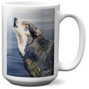 May include: White ceramic mug featuring a detailed painting of a howling wolf. The wolf has gray, brown, and white fur, set against a muted blue and gray background. The mug has a large handle for easy gripping and is suitable for hot or cold beverages.