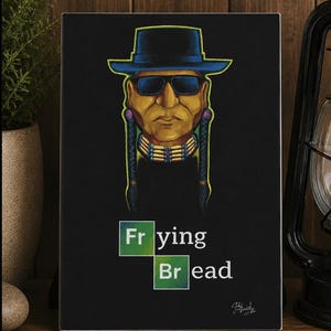 May include: A rectangular black sign featuring a stylized illustration of a person wearing a wide-brimmed hat, sunglasses, and a beaded choker with long braids. Below the illustration, the text reads "Fr ying Br ead" with green square accents.