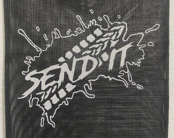 May include: Black mesh banner with a white paint splatter design. The splatter features the word "SEND IT" in a bold, stylized font.