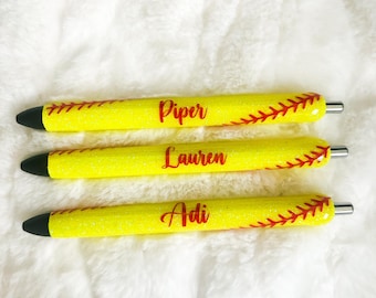 May include: Three yellow and red glitter pens with the names Piper, Lauren, and Adi written on them.