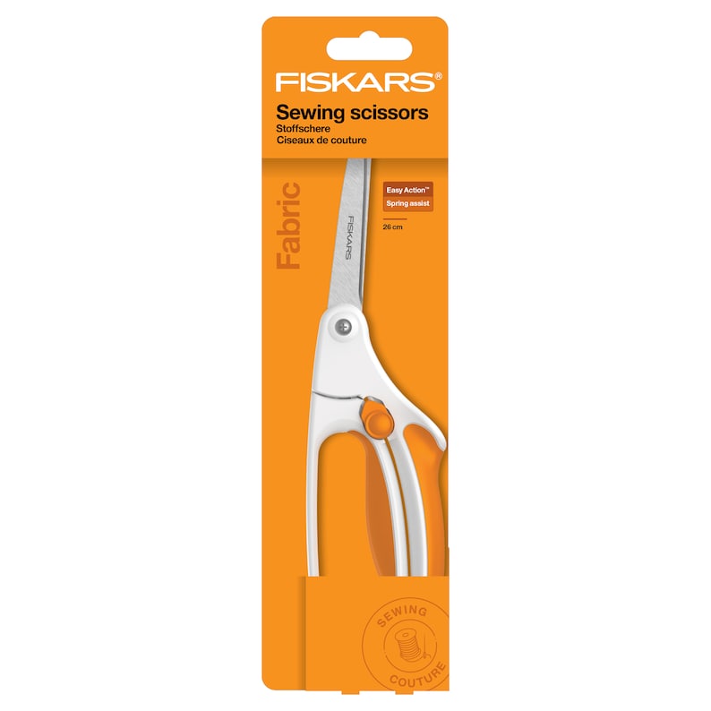 May include: Orange and white Fiskars Fabric sewing scissors with a spring assist feature. The scissors are 25 cm long and are packaged in a clear plastic sleeve.