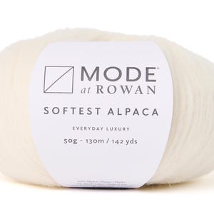 May include: A ball of white yarn labelled "MODE at ROWAN Softest Alpaca Everyday Luxury 50g - 130m / 142 yds"