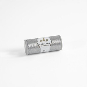 May include: A silver spool of DMC Diamant Grande embroidery thread. The spool has a white label with the DMC logo and the text "Diamant Grande".