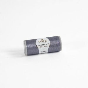 May include: A spool of DMC Diamant Grande embroidery thread in a silver gray color.