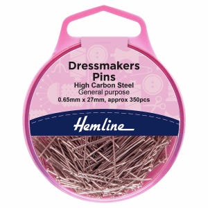 May include: A pink plastic container with a clear lid filled with silver dressmaker pins. The container has a pink handle and a label that reads "Dressmakers Pins, High Carbon Steel, General purpose, 0.65mm x 27mm, approx 350pcs, Hemline".