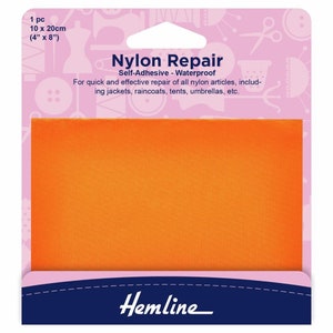May include: A package of orange self-adhesive waterproof nylon repair fabric. The package is pink with a white border and says "Nylon Repair Self-Adhesive - Waterproof" and "For quick and effective repair of all nylon articles, including jackets, raincoats, tents, umbrellas, etc." The package also says "Hemline".