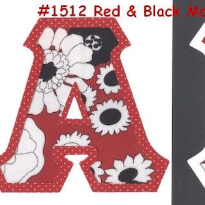 May include: Red and black fabric letters A and K with a white floral pattern. The letters are outlined in white and have a white dotted border. The letters are on a black background. #1512 Red & Black Mod Floral