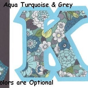 May include: Two fabric letters, A and K, in a teal, aqua, turquoise and grey floral pattern. The letters have a light blue border. #962 Shades of Teal Aqua Turquoise & Grey Border Colors are Optional