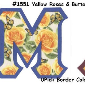 May include: Two large letters, "M" and "A", with a yellow rose and butterfly pattern. The letters have a blue and maroon border, respectively. The text "#1551 Yellow Roses & Butterflies" is above the letters. The text "UPick Border Color" is below the letters.